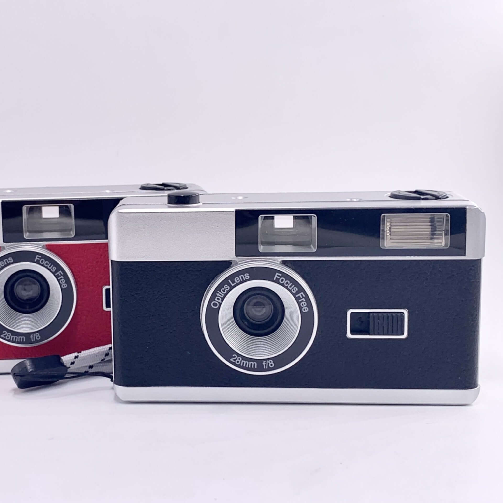 Retro 35mm film cameras in black and red with built-in flash and fixed 28mm lens.