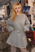 Young woman in a gray long-sleeved dress with a belt, styled for a casual weekend look, suitable for ages 18-24.