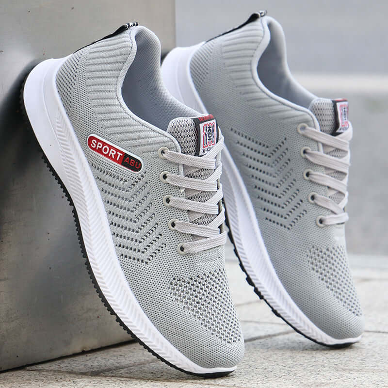 Breathable gray mesh sports shoes with lace-up design, ideal for casual wear and running.