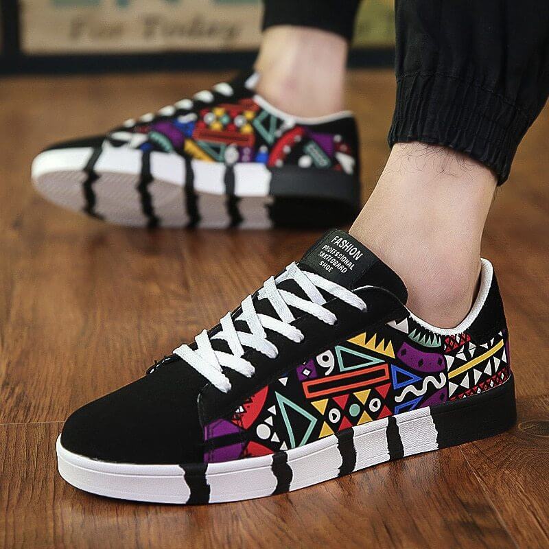 Colorful canvas shoes with geometric patterns and white laces on a wooden floor.