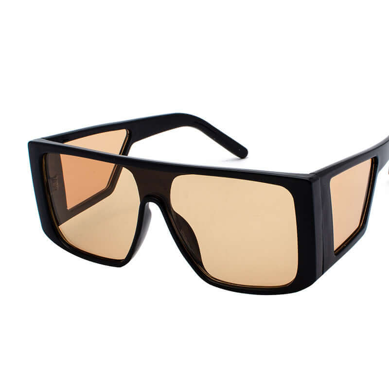 Retro sunglasses with large black frame and amber lenses, perfect for a bold, stylish look.