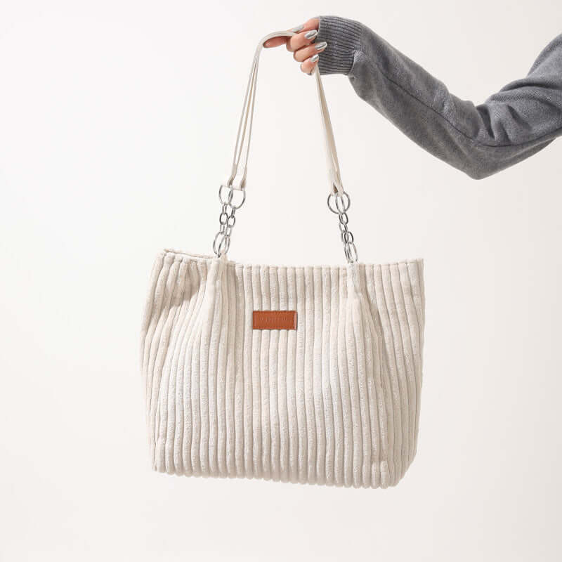 Creamy-white corduroy tote bag for women with double straps, ideal for autumn and winter daily outfits.