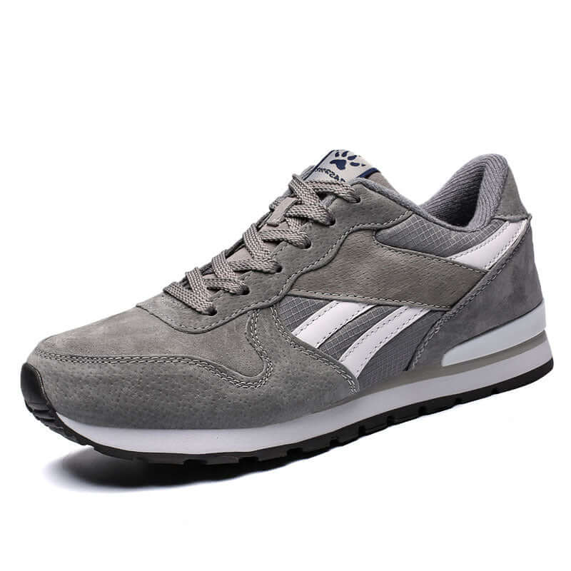 Mens casual running shoes in gray with white accents, featuring a low profile and rubber sole.